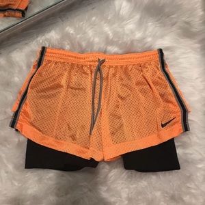 neon orange Nike shorts